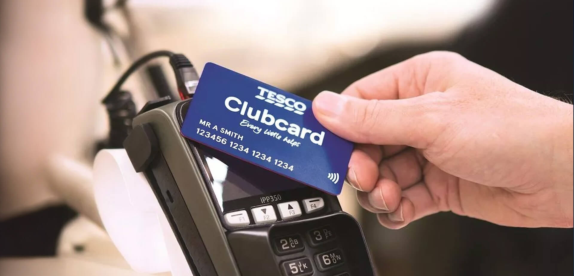 The image shows a Tesco Clubcard being used at a point of sale terminal.