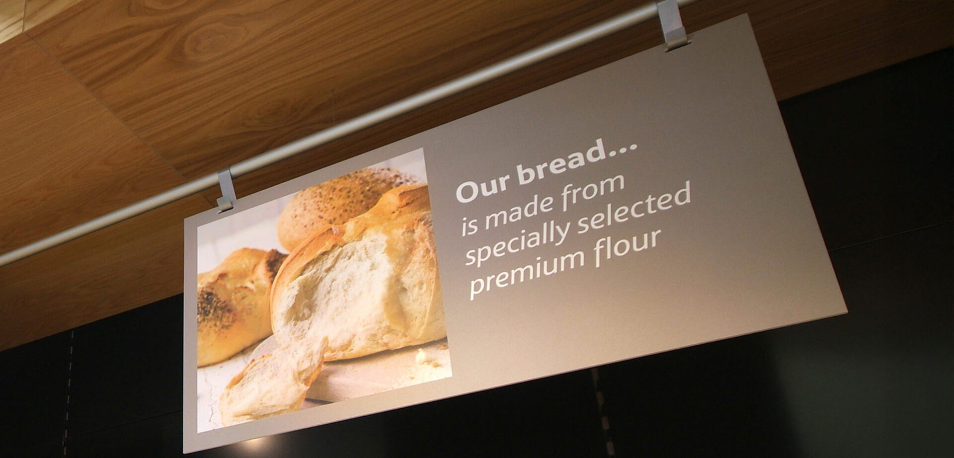 The Tesco Extra Hypermarket Accrington, Lancashire England. Bakery signage, the current range often includes "Everyday Favourites," "Tea Time Treats," and "Tesco Finest Signature Bakes," offering both standard and specialty items like tiger loaves, focaccia, and sourdough.