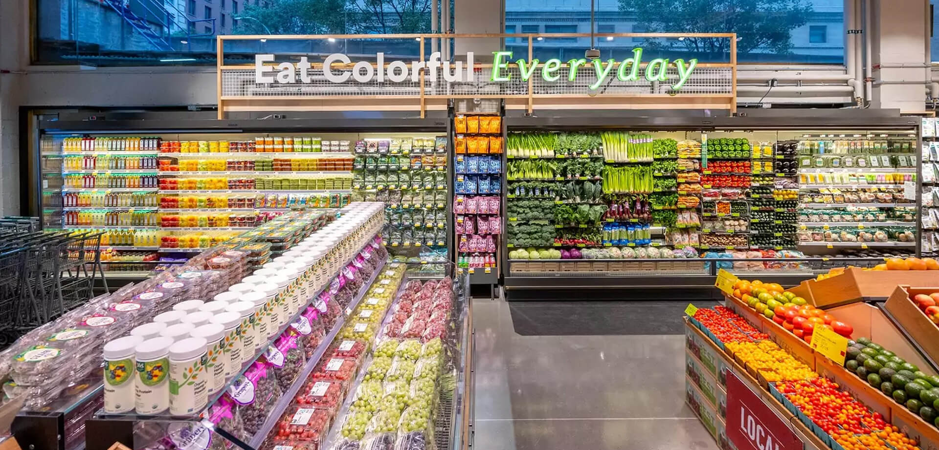 Whole Foods Market Daily Shop location, specifically highlighting the fresh produce section. The slogan "Eat Colorful Everyday" is a prominent part of the store's design concept, which emphasizes the variety and health benefits of colourful fruits and vegetables. Located in the Lenox Hill neighborhood of Manhattan, New York City