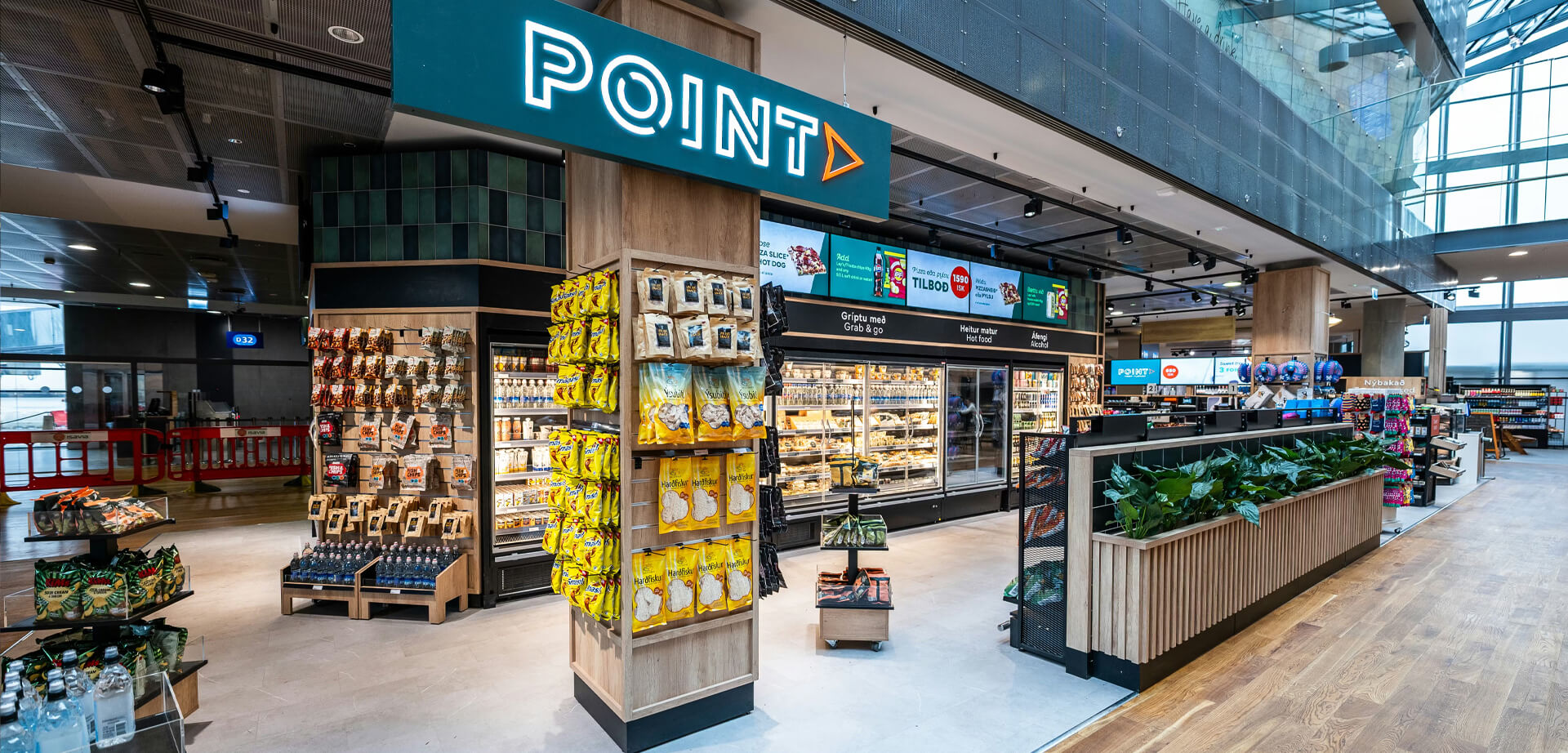 The image shows the interior of an SSP Point convenience store, a travel-focused brand commonly located in high-traffic environments such as airports and railway stations.