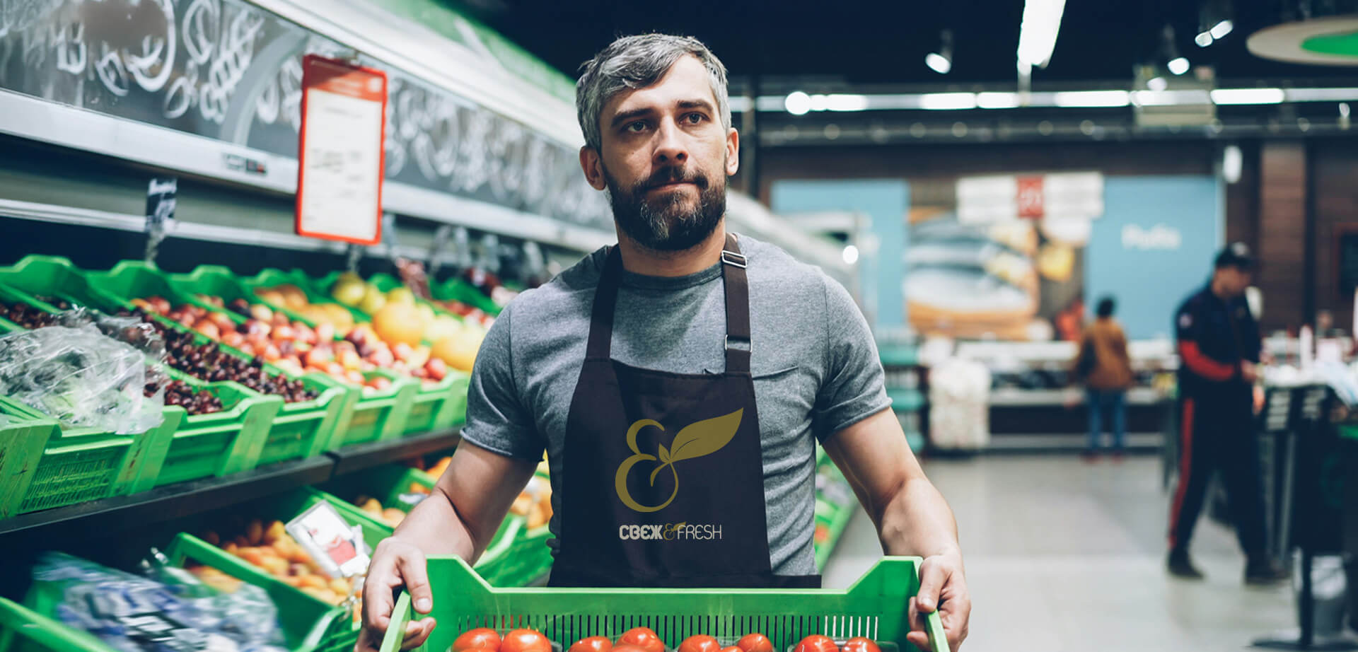 Fresh & Fresh fruit and vegetable department - Staff member with branded uniform.