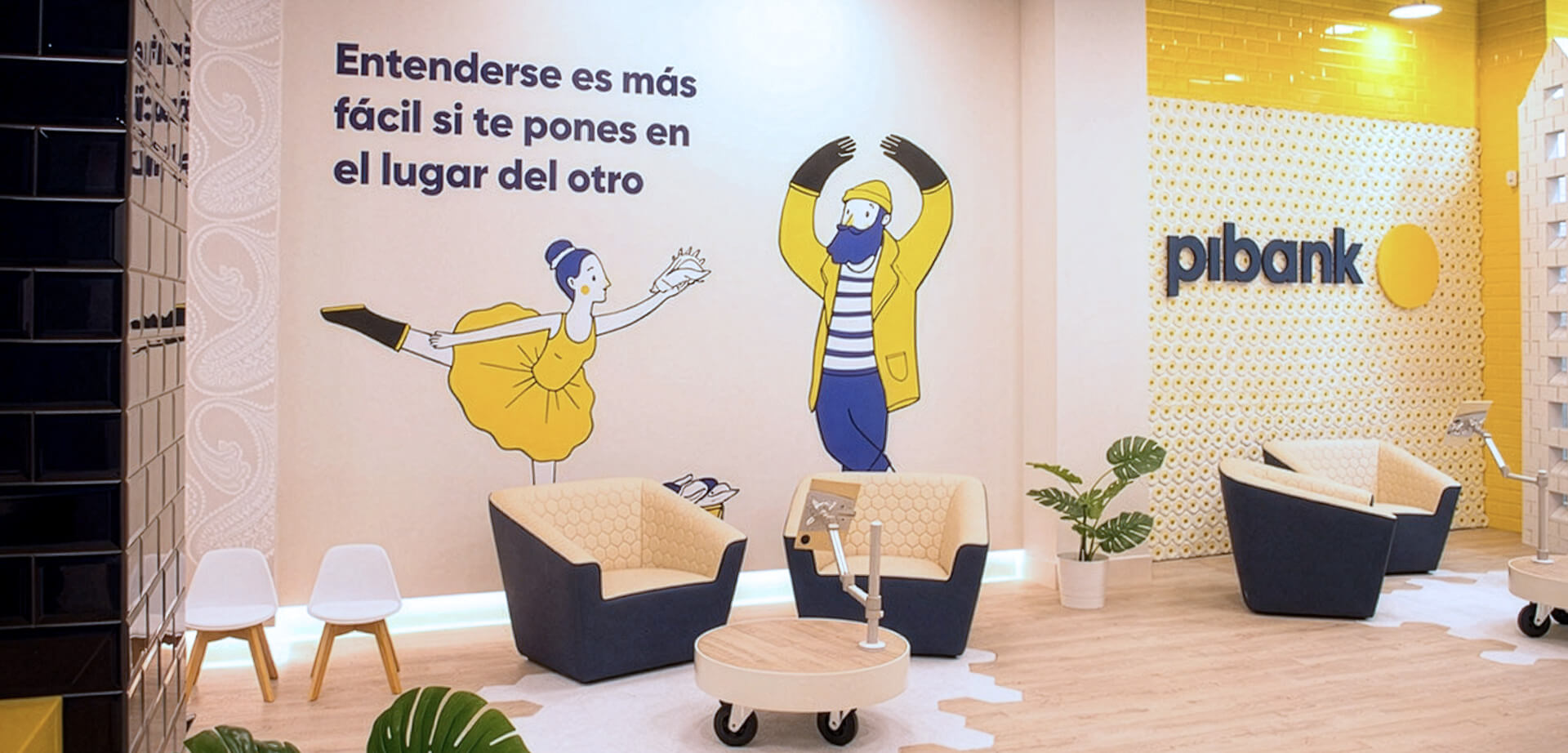 Pibank office, a digital bank that is part of the Pichincha banking group. The text on the wall conveys a message about empathy and understanding. 