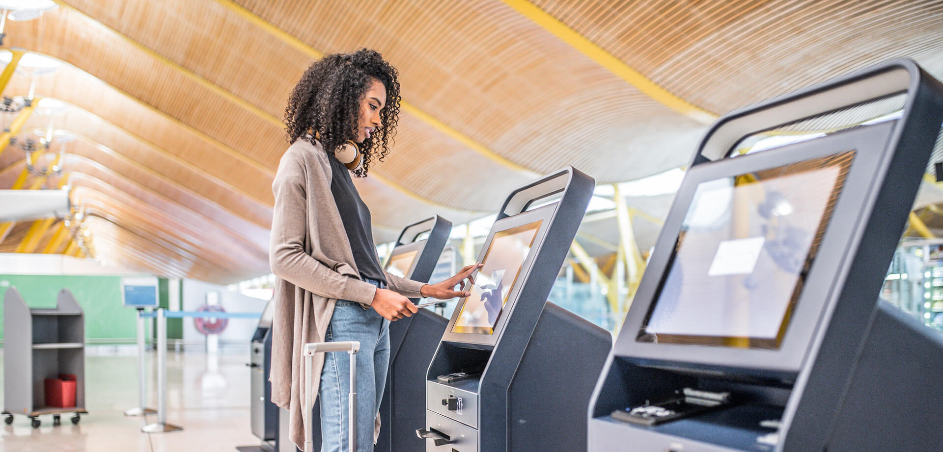 An airport check-in kiosk featuring a touchscreen interface for passengers to use.