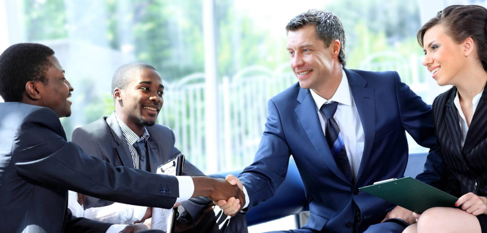 A professional team handshake during a corporate business meeting.