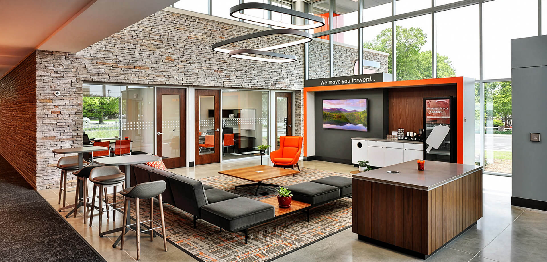 Carolina Foothills Credit Union. The credit union features a community showcase wall, teller pods, and this comfortable lobby that is meant to look more like a living room or modern coffee shop.