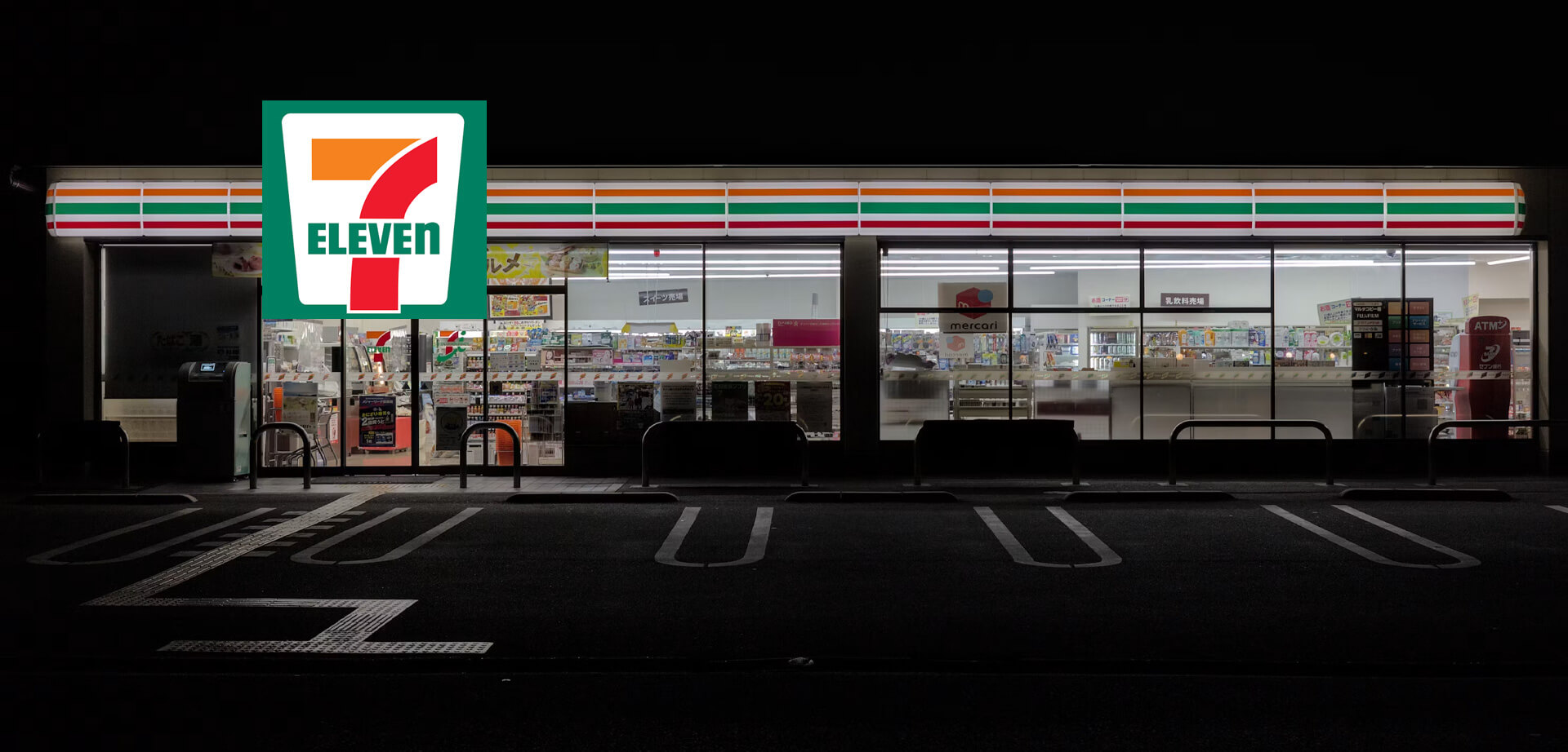 7-Eleven convenience store in Japan, known locally as a "konbini". These stores are famous for their modern, brightly lit storefronts and the wide variety of high-quality food and everyday items they offer.