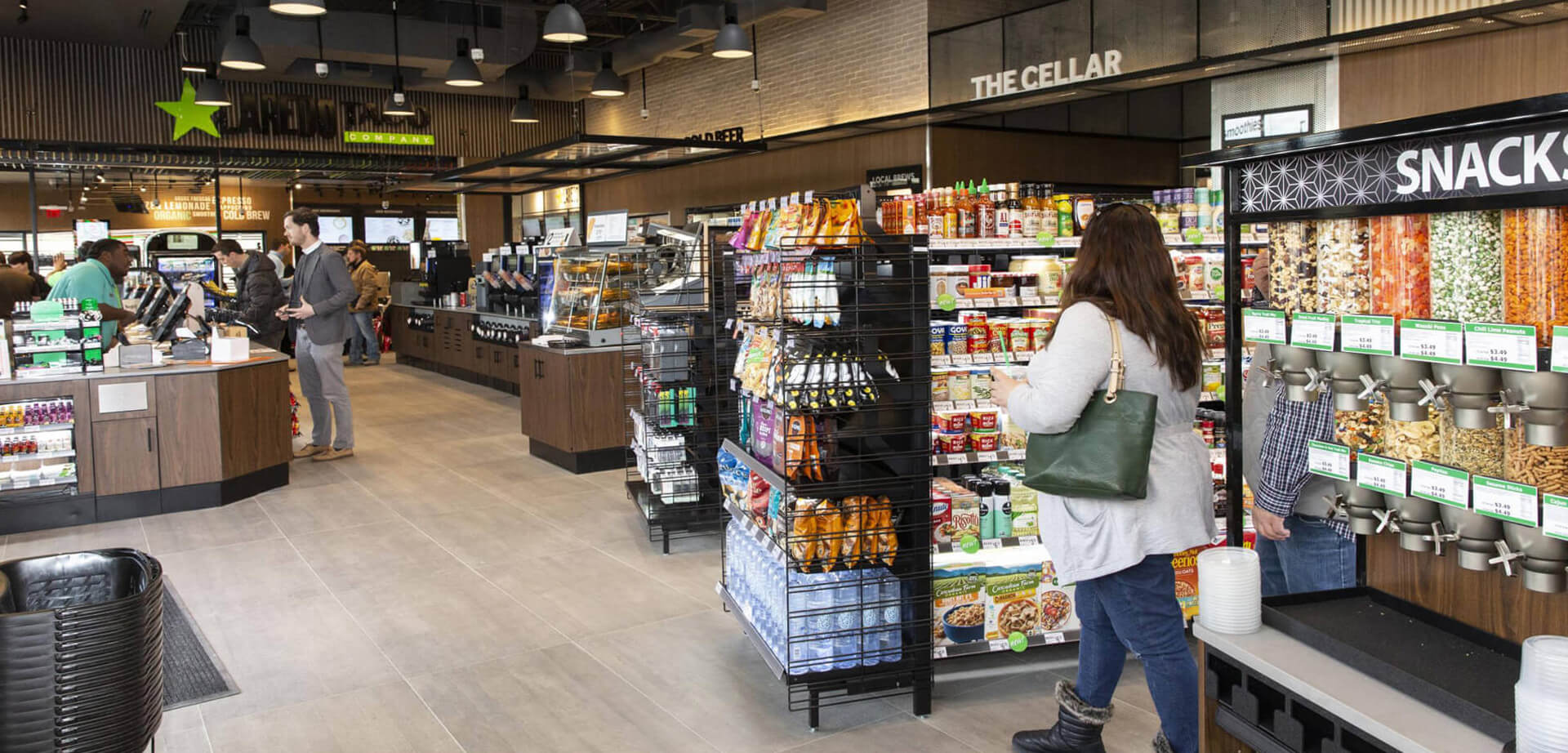 An innovative 7-Eleven concept store known for an elevated shopping experience, featuring specialized zones like "The Cellar" for beer and wine, and a bulk candy and snack wall.