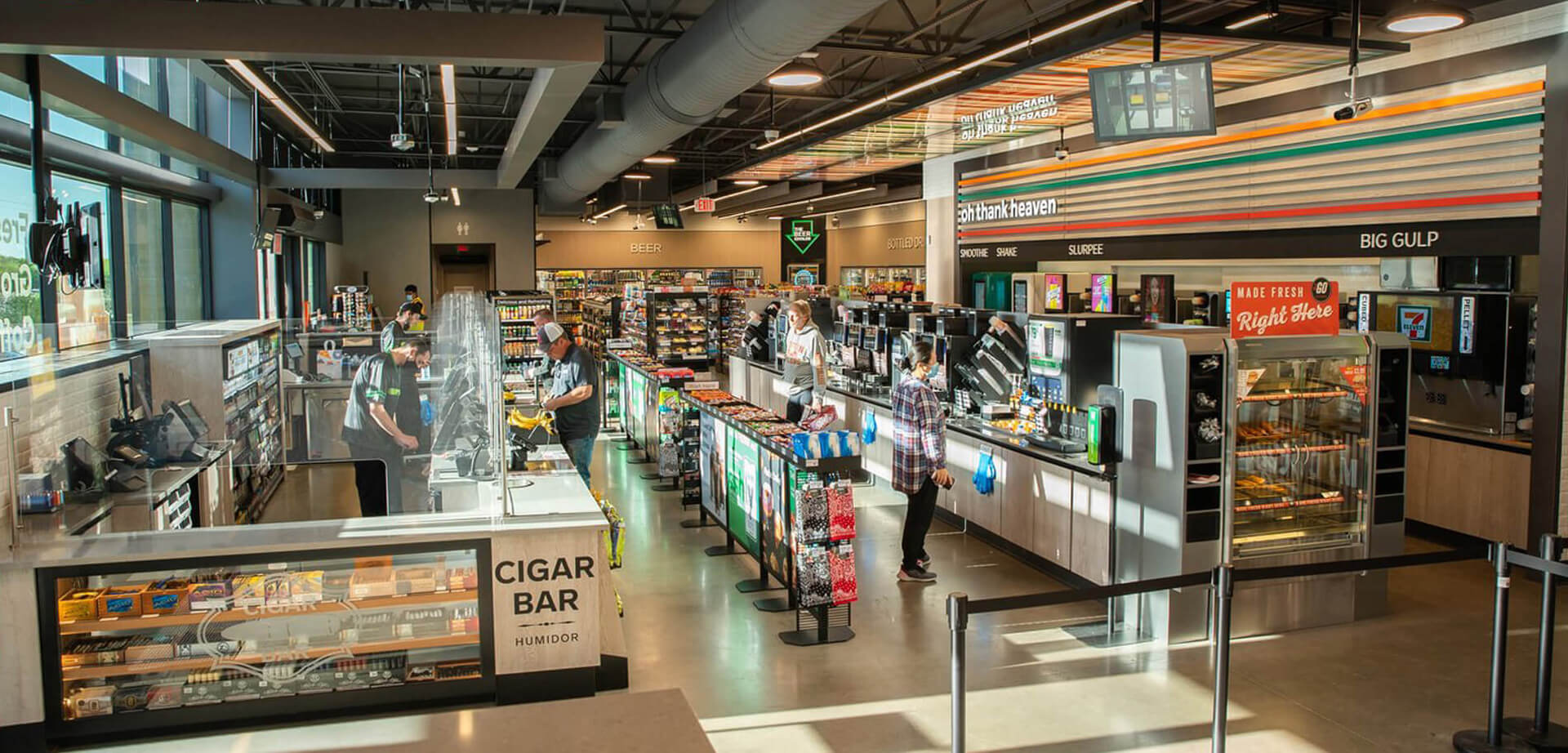 Dallas, Texas 7-Eleven Evolution Store, an experiential retail concept designed to test new foodservice and shopping innovations. Unlike traditional stores, these locations feature unique offerings like a premium walk-in cigar humidor, mobile checkouts, and custom hot food and beverage stations.