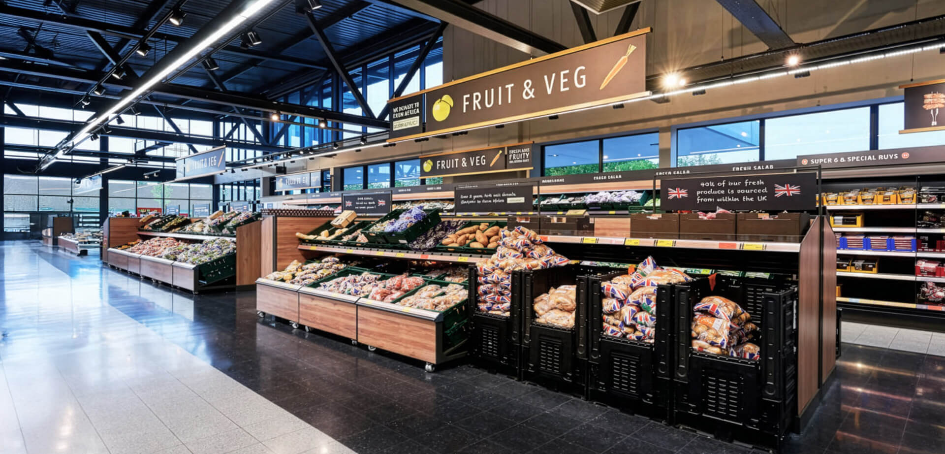 A modern Aldi supermarket interior, specifically featuring their "Project Fresh" store redesign. This updated layout is designed to maximize space and improve the shopping experience for fresh groceries.