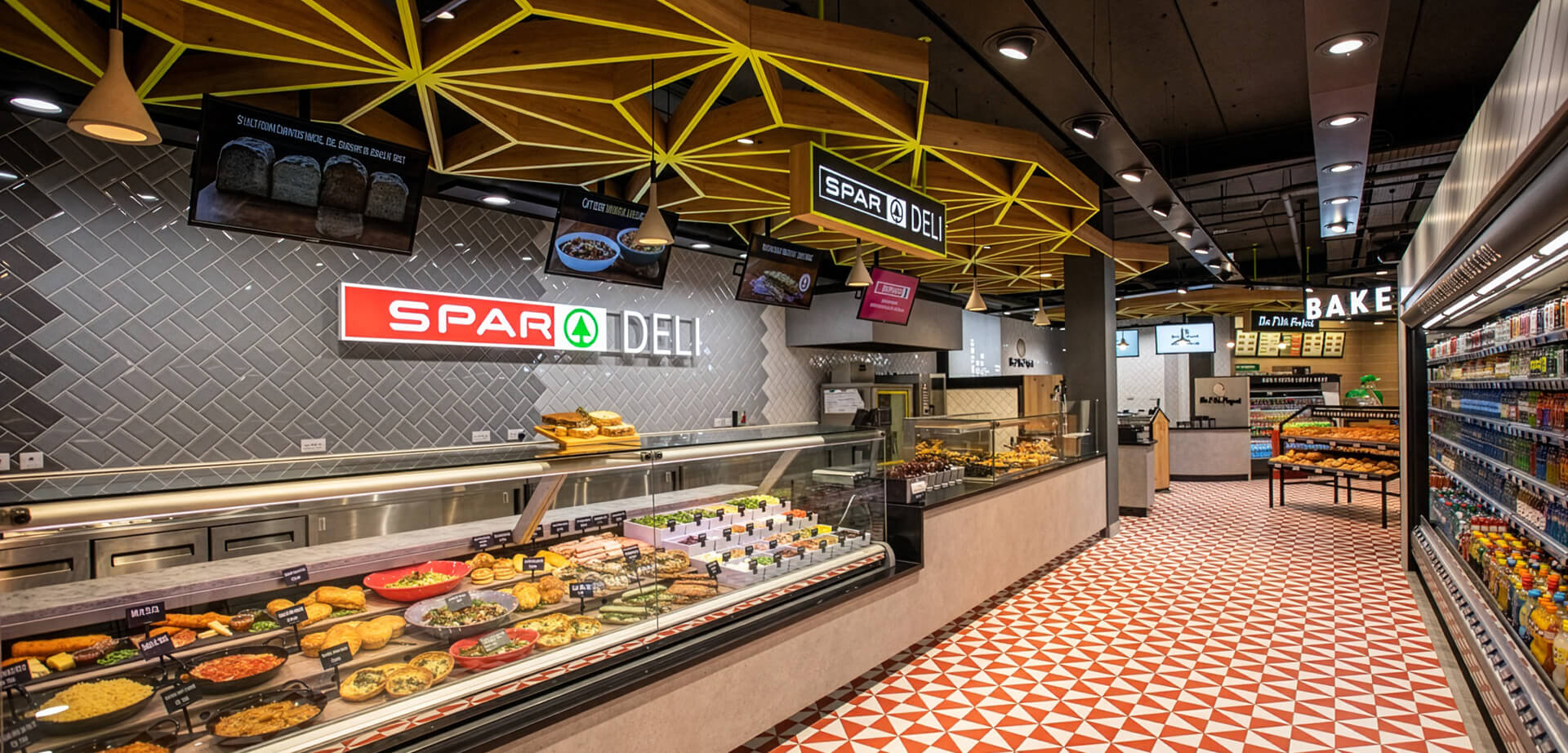 A modern Spar Deli in-store food-to-go concept, featuring a glass display counter with freshly prepared meals and salad