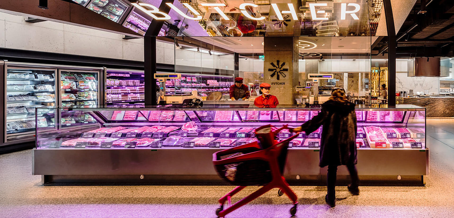 SSG market is famous for blending a premium supermarket with a food hall, featuring a modern, sleek interior and highly visible, mirrored graphic treatments like the glowing "SEAFOOD" sign.