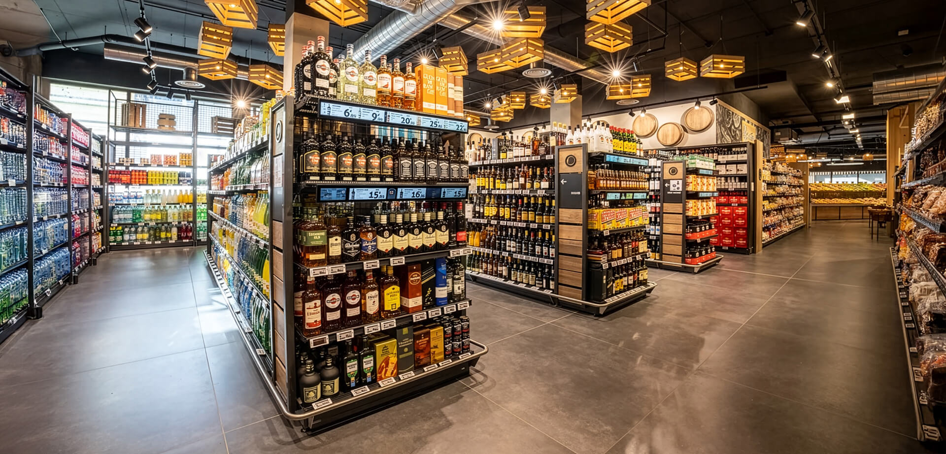E.Leclerc shows a beautifully organised modern liquor and grocery section, likely inside a large supermarket, featuring tall, well-lit shelving units stocked with a wide variety of wine, spirits, and other bottled beverages.