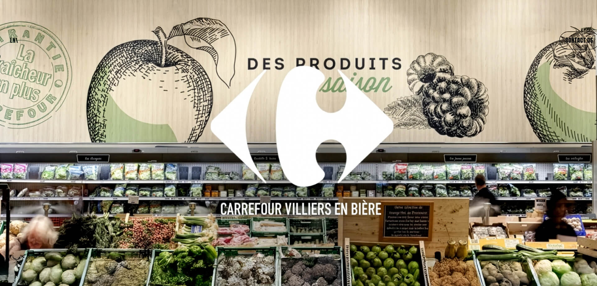 The image shows a produce section at a Carrefour supermarket, featuring a large Carrefour logo, wooden wall panels, and oversized chalk-style drawings of fresh fruits.