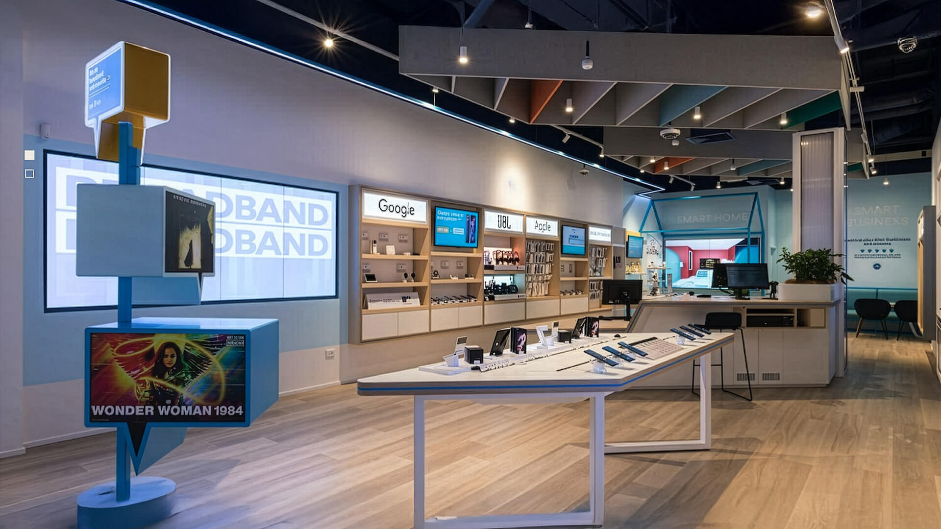 This image shows the interior of 2degrees telecommunications retail store featuring branded wall shelving for tech brands like Google, JBL, and Apple.