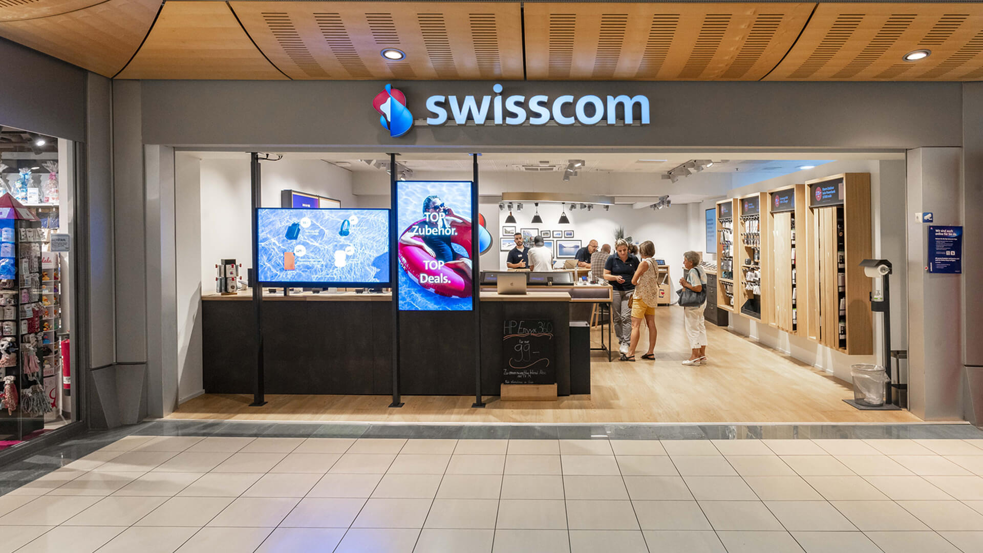 The storefront of a Swisscom retail shop, the leading telecommunications provider in Switzerland.