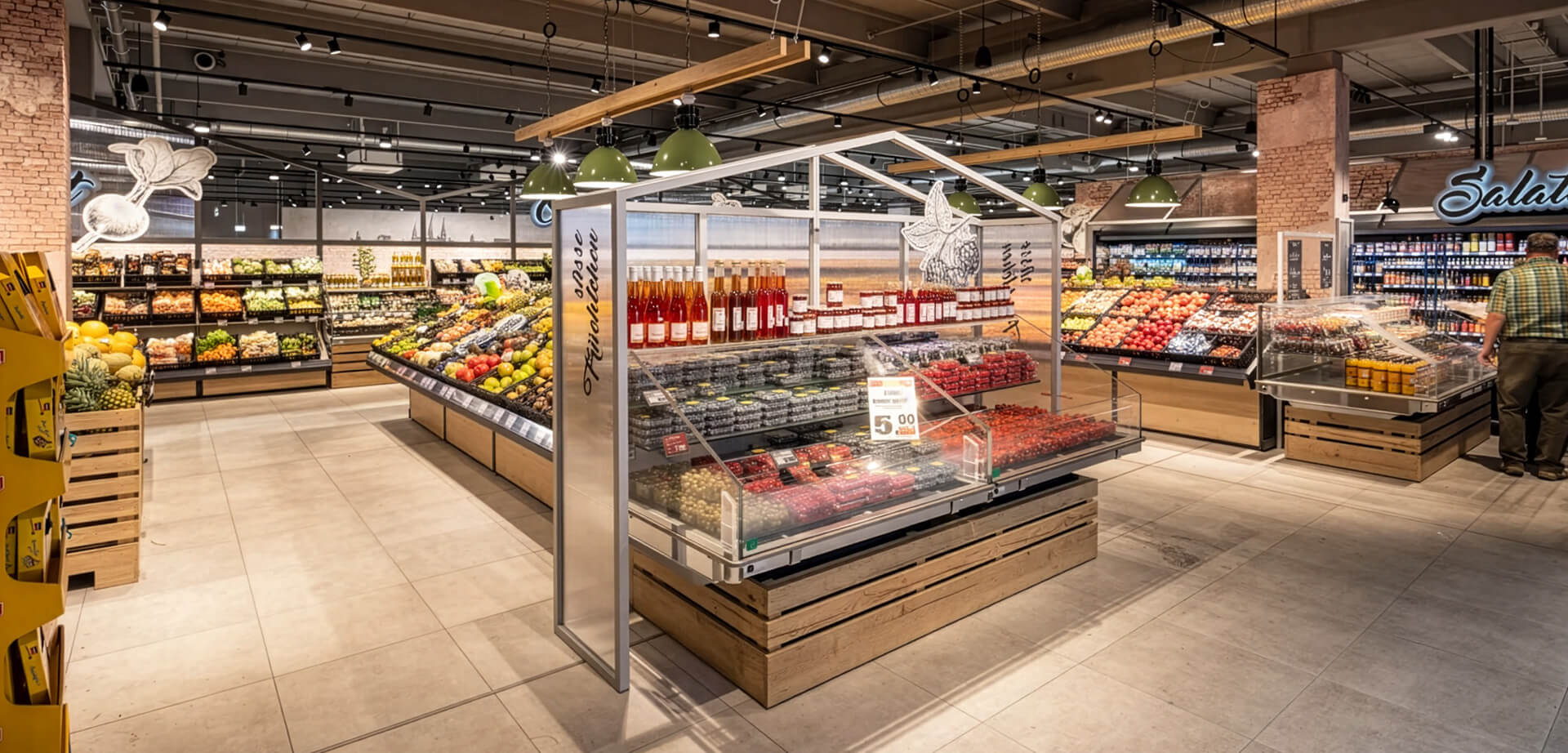 The fresh produce and greenhouse-style display area inside the Edeka Massak supermarket in Bamberg, Germany.