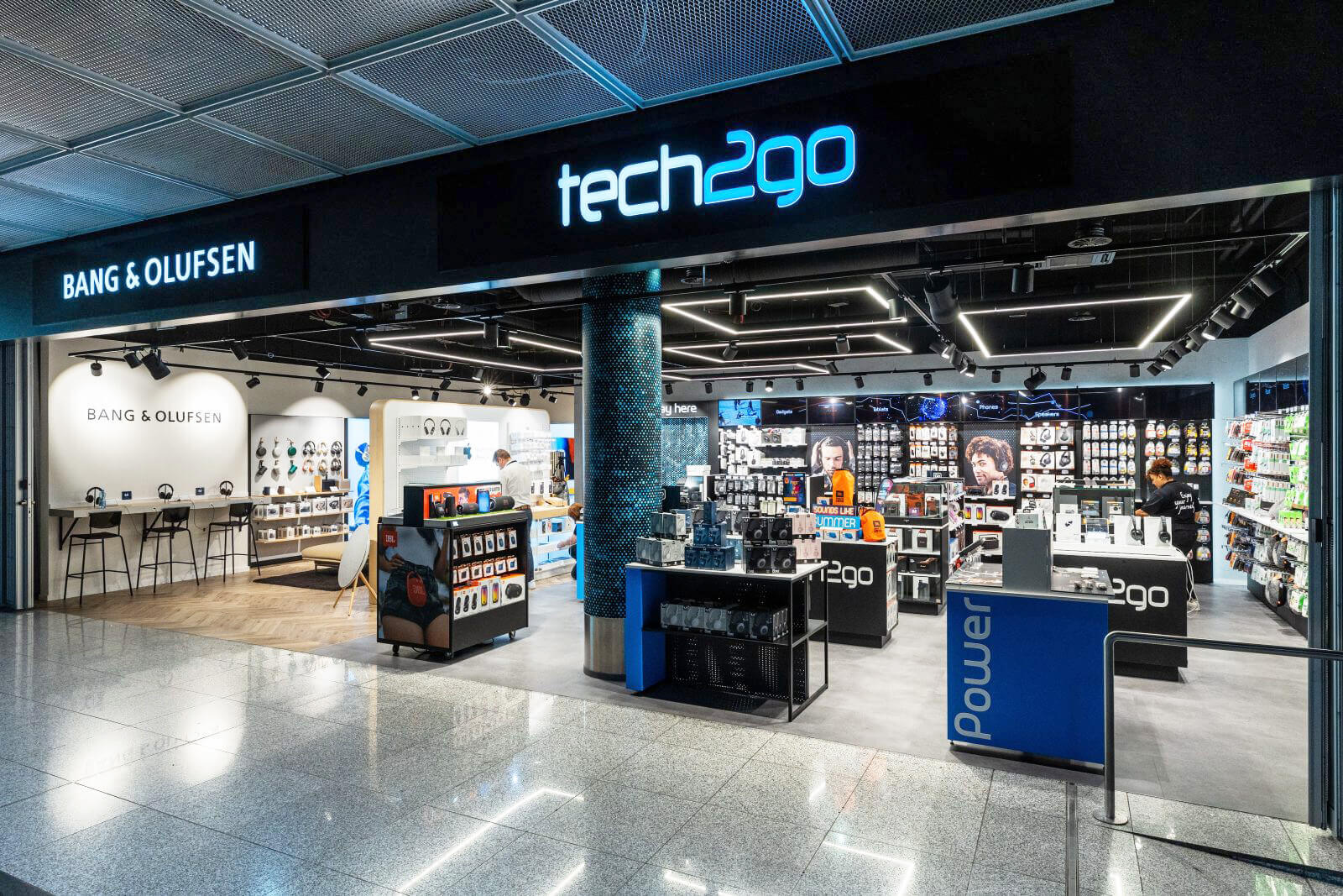 A tech2go travel electronics store featuring an integrated Bang & Olufsen lounge and retail space at Frankfurt Airport.