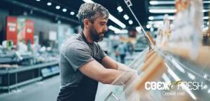 This image shows a Свеж & Fresh (Svezh & Fresh) grocery store employee stocking the fresh bread sect